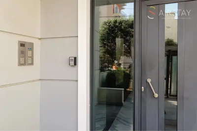 a glass door of a building with a window at Akali Apartment airport by Airstay in Spáta