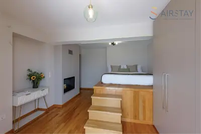 a bedroom with a bed and a fireplace at Akali Apartment airport by Airstay in Spáta