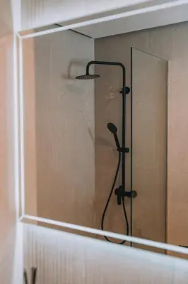 a shower with a shower head in a bathroom at Chic Apartment near Acropolis in Athens
