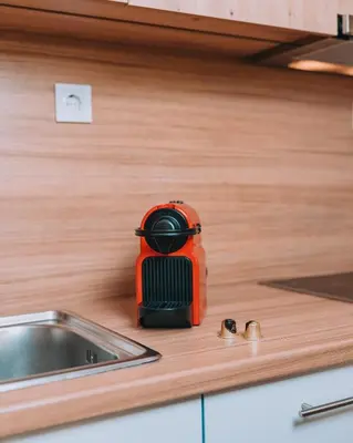 an orange toaster sitting on top of a kitchen counter at Chic Apartment near Acropolis in Athens