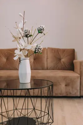 a vase with flowers on a table in a living room at Chic Apartment near Acropolis in Athens