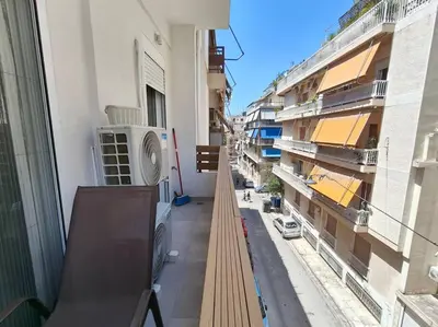 a balcony of a building with a view of a street at Chic Apartment near Acropolis in Athens