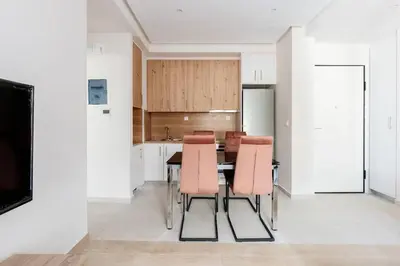a kitchen with a table and chairs in a room at Chic Apartment near Acropolis in Athens