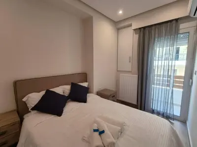 a bedroom with a bed with towels on it at Chic Apartment near Acropolis in Athens