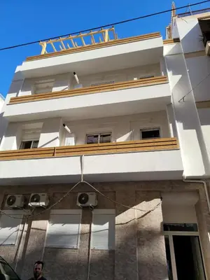 a man standing in front of a white building at Chic Apartment near Acropolis in Athens