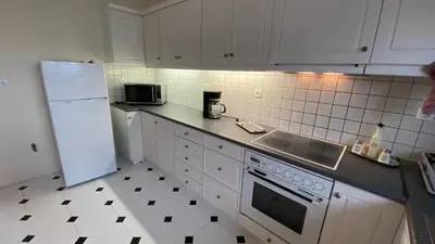 a kitchen with a white refrigerator and a sink at Athens center vintage maisonete in Athens
