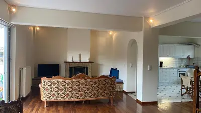 a living room with a couch and a kitchen at Athens center vintage maisonete in Athens