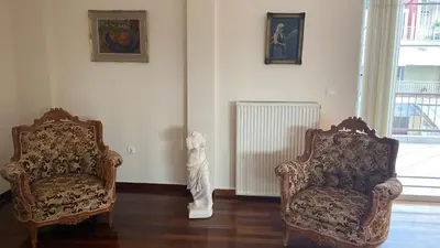 two chairs and a radiator in a living room at Athens center vintage maisonete in Athens