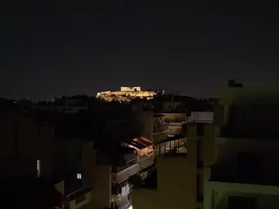 a city at night with a building in the background at Athens center vintage maisonete in Athens