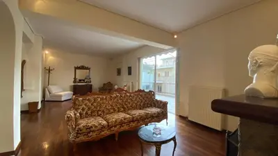 a living room with a couch and a large window at Athens center vintage maisonete in Athens