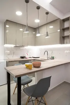 a kitchen with a wooden table and chairs at Lenorman Apartments in Athens