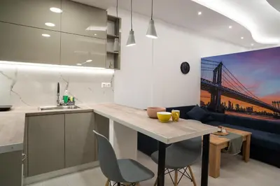 a kitchen with a table and chairs and a couch at Lenorman Apartments in Athens