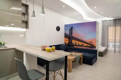 a kitchen and living room with a bridge painting on the wall at Lenorman Apartments in Athens