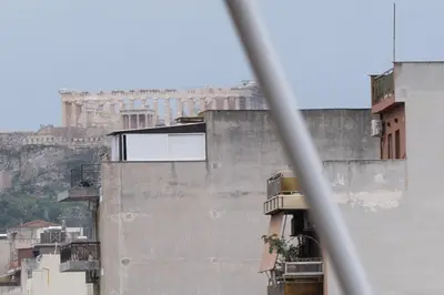 a view of the acropolis from a building with at Lenorman Apartments in Athens