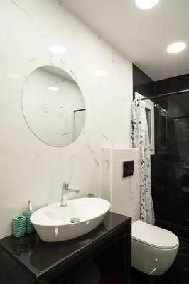 a bathroom with a sink and a toilet and a mirror at Lenorman Apartments in Athens