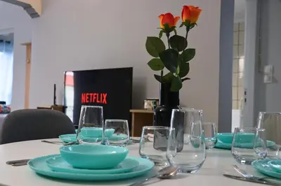 a table with glasses and a vase with a flower at Athens Marialena Apartment in Athens