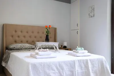 a bed with a white table with towels on it at Athens Marialena Apartment in Athens