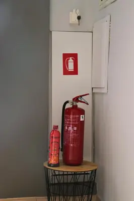 a red fire hydrant sitting on a table next to a refrigerator at Athens Marialena Apartment in Athens