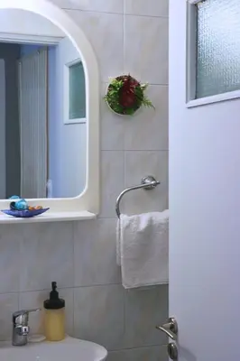 a bathroom with a sink and a mirror at Athens Marialena Apartment in Athens