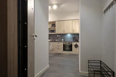a kitchen with a door open to a room at Chic Apt with All Comforts in the Heart of Athens! in Athens