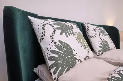 a green couch with three pillows on it at Chic Apt with All Comforts in the Heart of Athens! in Athens