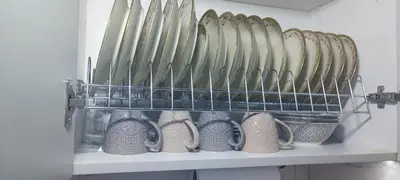 a shelf with a bunch of plates and vases at Pnoé d Athéna in Athens