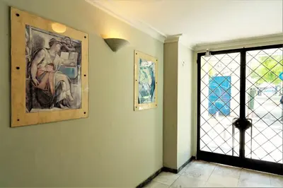 a room with a painting on the wall and a window at Pnoé d Athéna in Athens