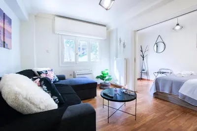 a living room with a couch and a bed at Glamorous Apt in Kolonaki in Athens