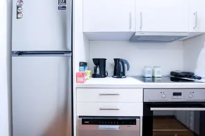 a small kitchen with a refrigerator and a stove at Glamorous Apt in Kolonaki in Athens