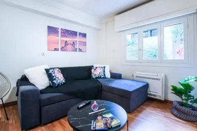 a living room with a couch and a table at Glamorous Apt in Kolonaki in Athens