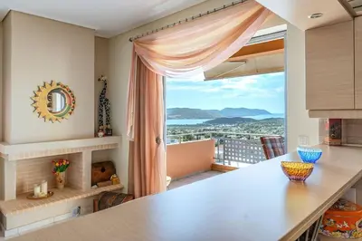 a kitchen with a large window with a view at Anavissos Seaview Holiday Home in Anavissos