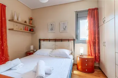a bedroom with a bed with towels on it at Anavissos Seaview Holiday Home in Anavissos