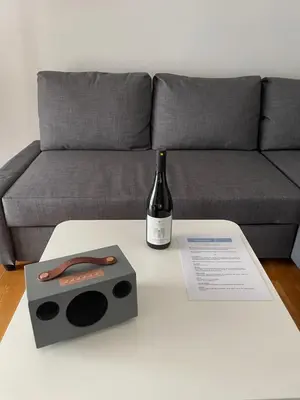 a bottle of wine on a table next to a couch at Cityspace Apartment, Athens in Athens
