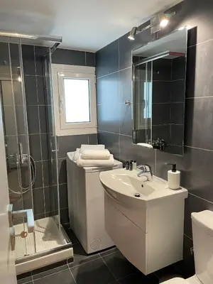 a bathroom with a sink and a shower and a toilet at Cityspace Apartment, Athens in Athens