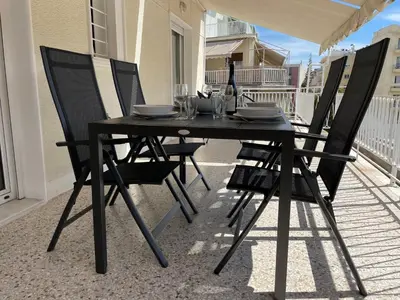 a black table and chairs on a balcony at Cityspace Apartment, Athens in Athens