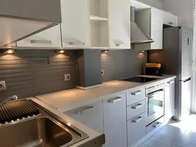 a kitchen with white cabinets and a sink at Cityspace Apartment, Athens in Athens