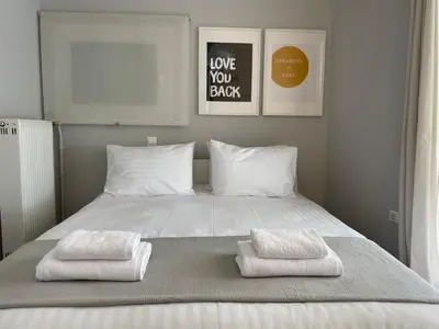 a bed with two white towels on it at Cityspace Apartment, Athens in Athens