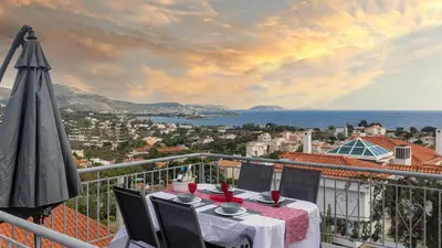 a balcony with a table and an umbrella at Bunny island- seaview house, private garden , Lagonisi, Attika riviera by Comfortbnb in Lagonissi