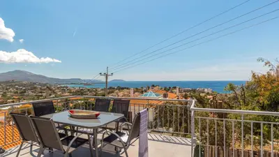 a patio with a table and chairs on a balcony at Bunny island- seaview house, private garden , Lagonisi, Attika riviera by Comfortbnb in Lagonissi