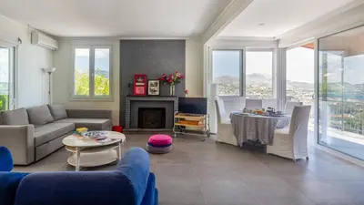 a living room with a couch and a table at Bunny island- seaview house, private garden , Lagonisi, Attika riviera by Comfortbnb in Lagonissi