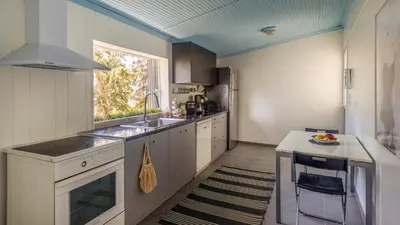 a kitchen with white cabinets and a sink and a window at Bunny island- seaview house, private garden , Lagonisi, Attika riviera by Comfortbnb in Lagonissi