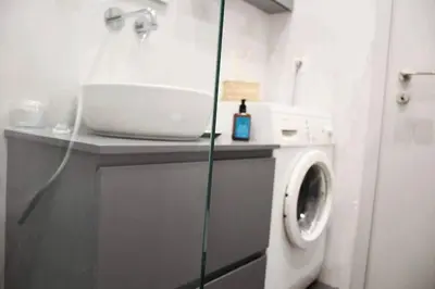 a bathroom with a washing machine and a washer at central Athens apartment near Kallimarmaro hosted by vasiliki in Athens