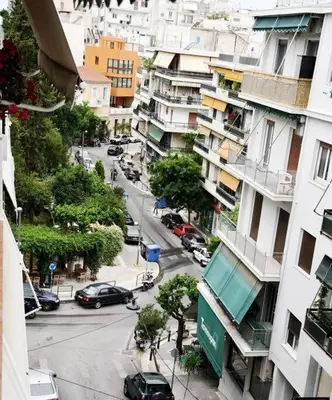 a view of a city street with cars and buildings at central Athens apartment near Kallimarmaro hosted by vasiliki in Athens