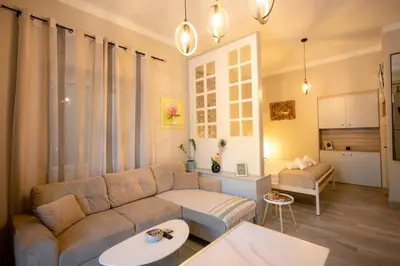 a living room with a couch and a table at Peacock's Apartments in Piraeus