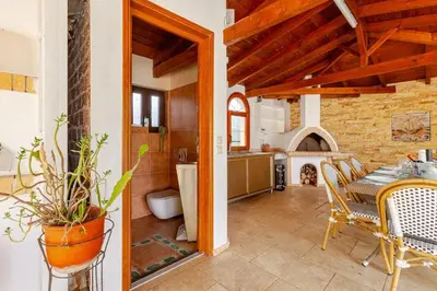 a kitchen and a dining room with a table and chairs at Riviera Paradiso in Aghia Marina