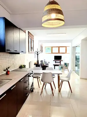 a kitchen with a table and chairs and a dining room at Riviera Paradiso in Aghia Marina