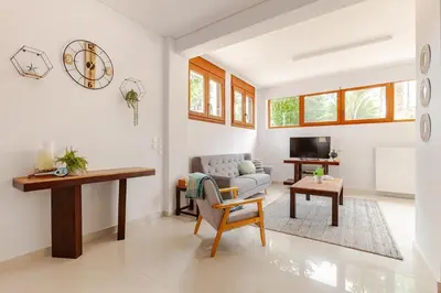 a living room with a couch and a table at Riviera Paradiso in Aghia Marina