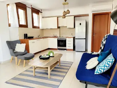 a living room with a blue couch and a table at Riviera Paradiso in Aghia Marina