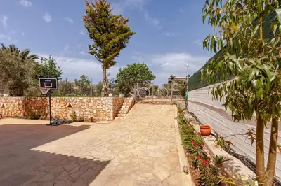 an empty basketball court with a basketball hoop at Riviera Paradiso in Aghia Marina