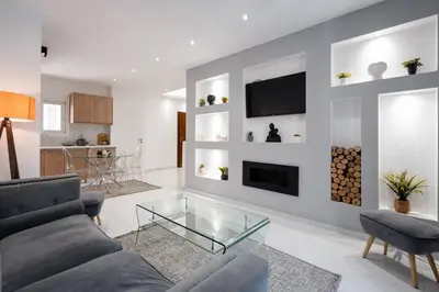 a living room with a couch and a tv at “Athens Cosmos” Apartment in Neos Kosmos in Athens